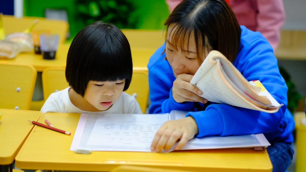 woman teaching girl