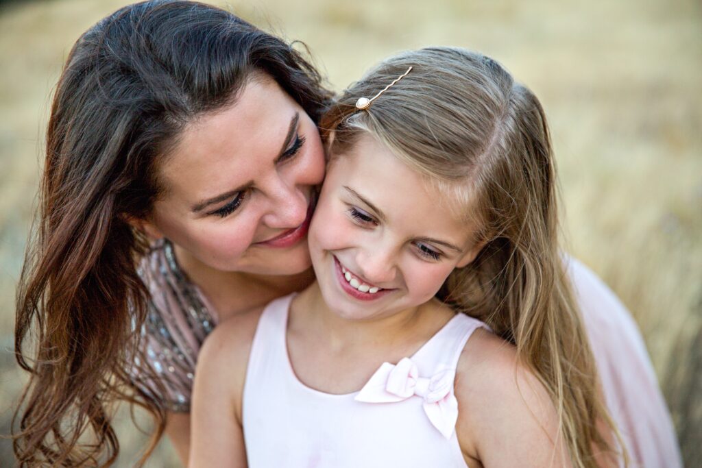 mother kissing her daughter