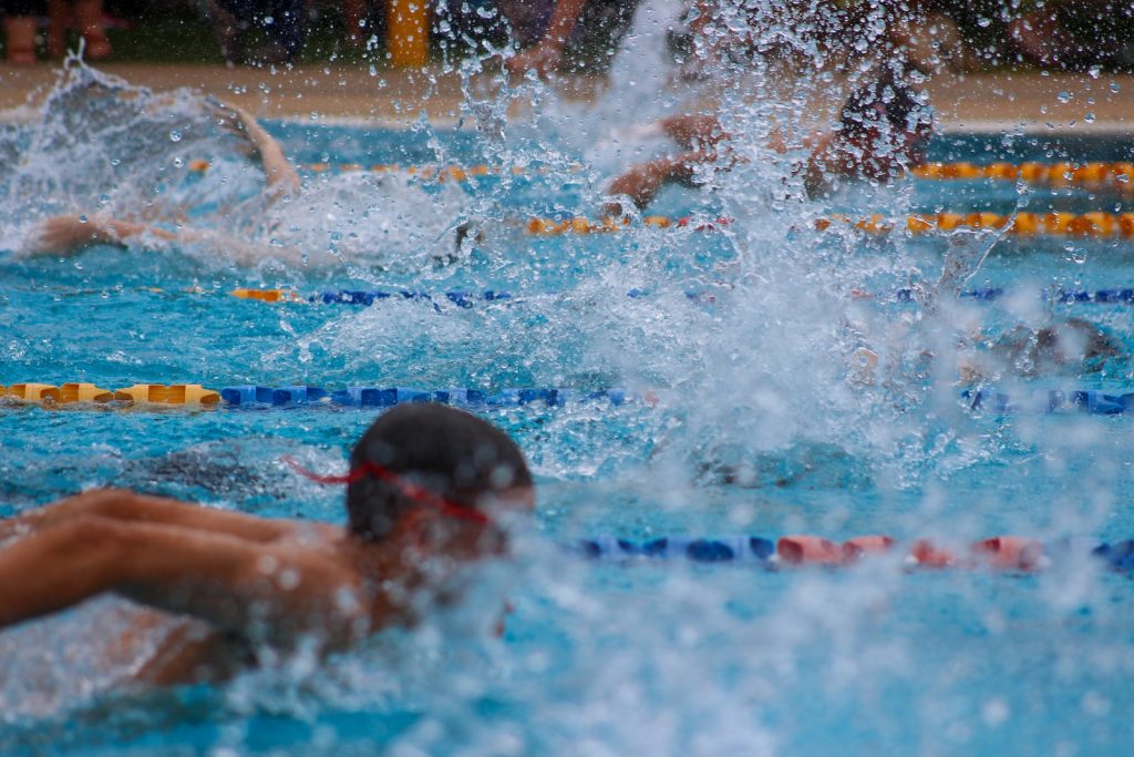 man in swimming pool during daytime