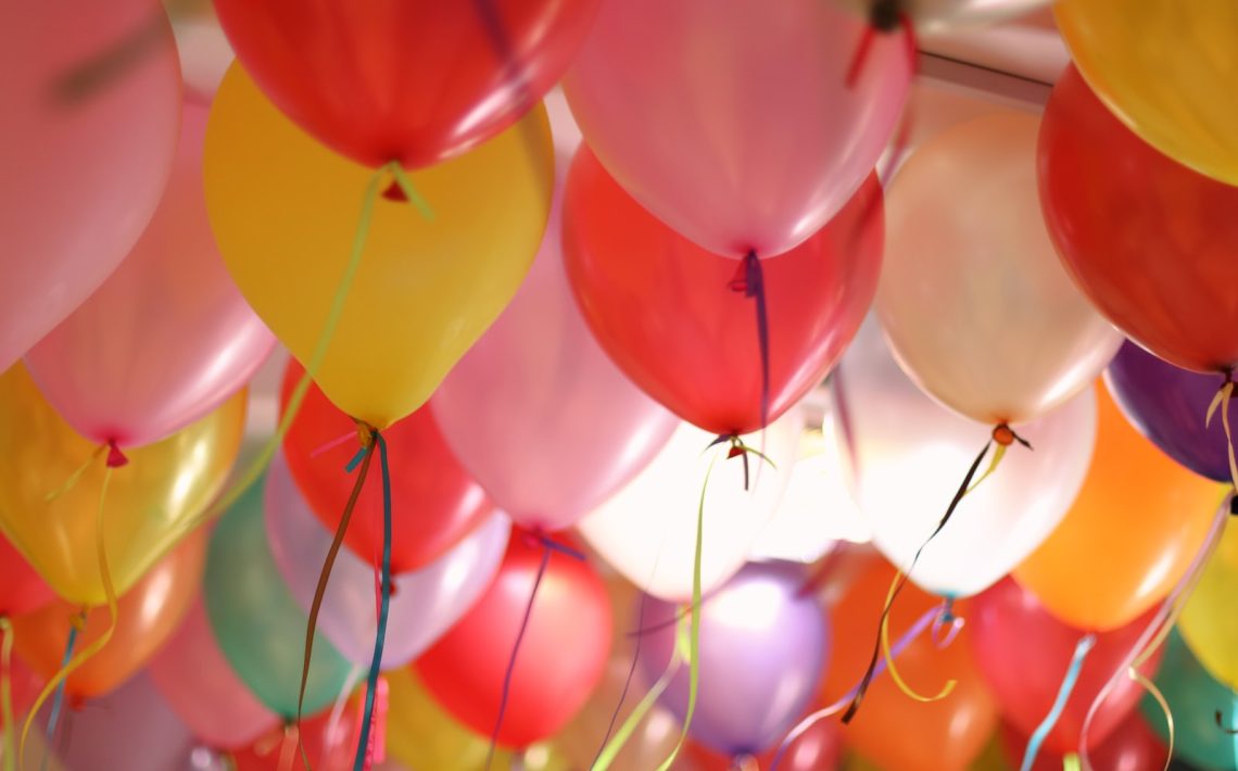 pink and yellow balloons in close up photography