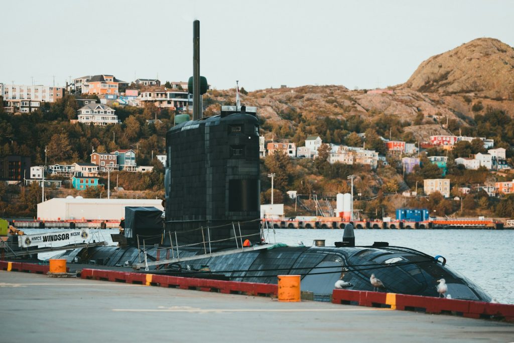 a large black submarine sitting on top of a body of water