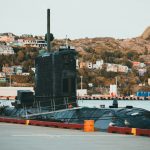 a large black submarine sitting on top of a body of water