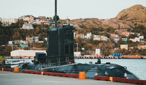 a large black submarine sitting on top of a body of water